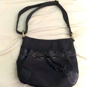A black purse with an adjustable strap